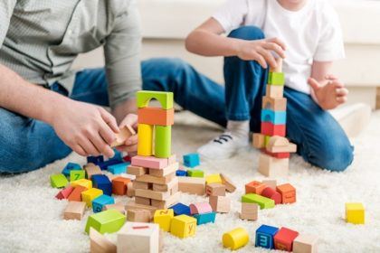 parent and child playing with building blocks