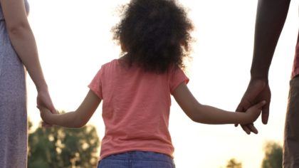 Daughter holding parents hands