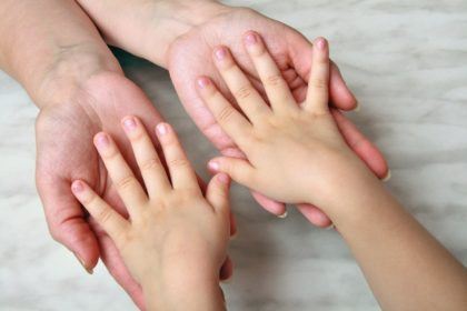 Parent hands and child hands