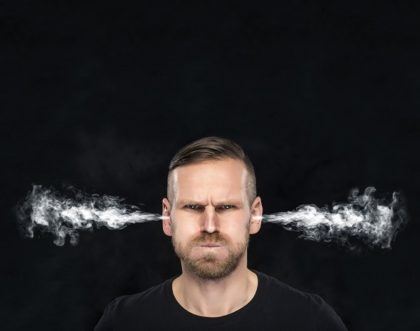 man blowing smoke out of his ears