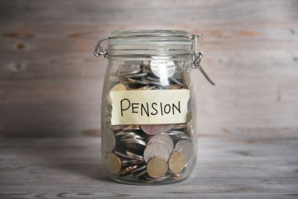 mason jar with the word pension written on it and coins inside