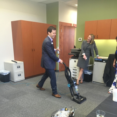 Eric-vacuuming-office-in-a-suit-at-Woodbury-opening