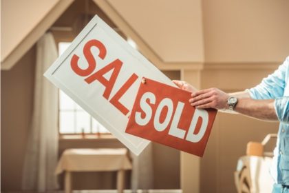 woman holding a sale sign