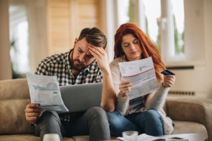 couple looking at papers with disdain