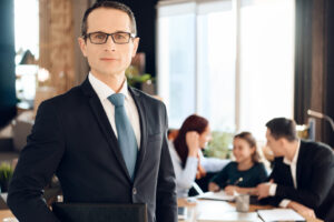 Confident adult man in suit stands in front of office of family lawyer. Dissolution of marriage of two adults. Family in office of family lawyer.
