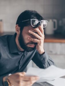 Unhappy man reading divorce papers