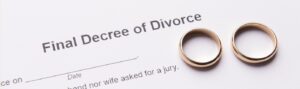 Two golden wedding rings on final divorce decree document