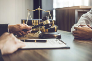 Gavel striking and papers being reviewed by judge
