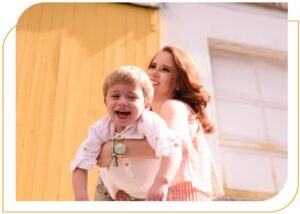 white woman holding 5-6 year old boy and both smiling