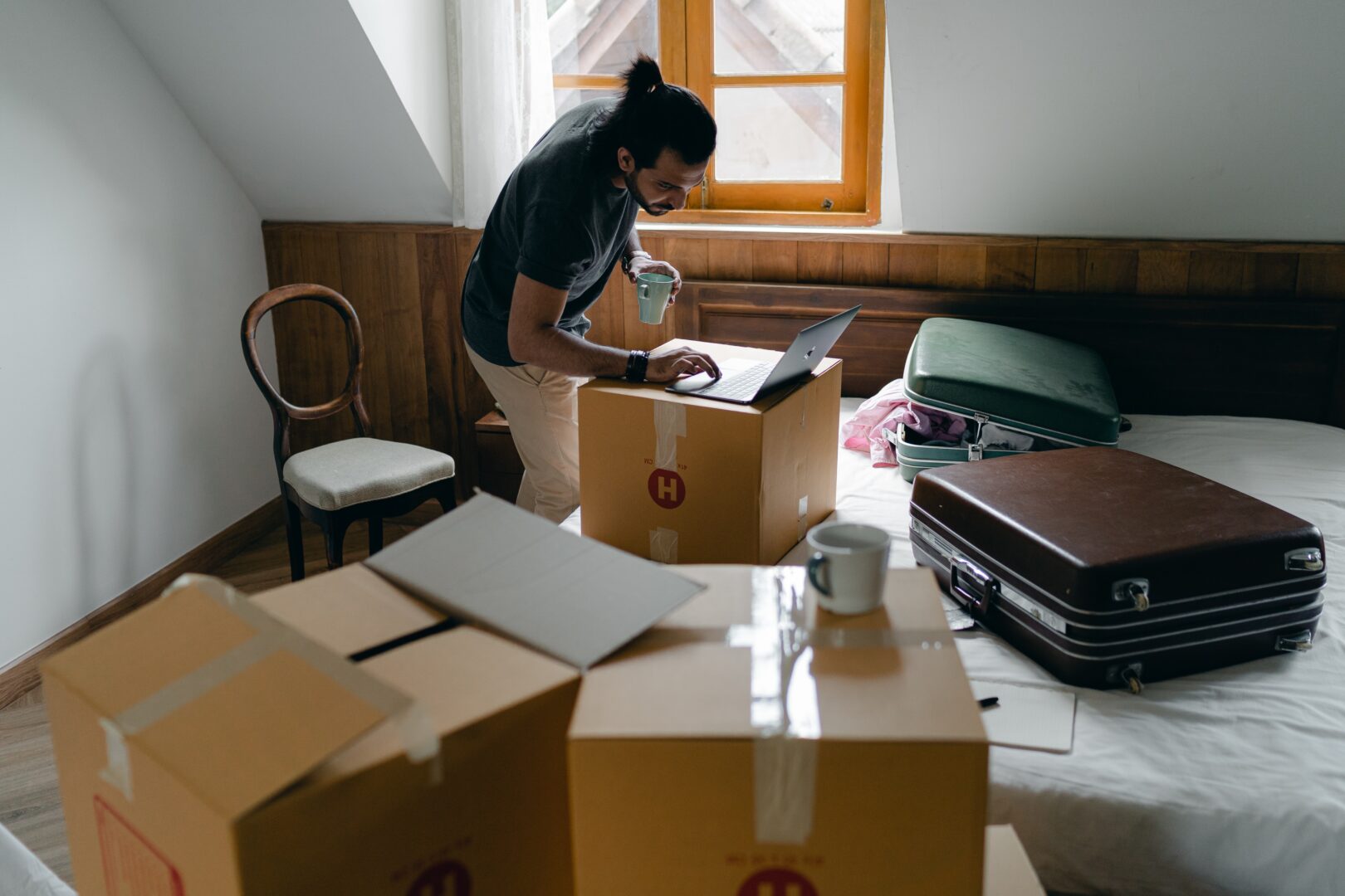 Man in a room packing boxes - division of assets
