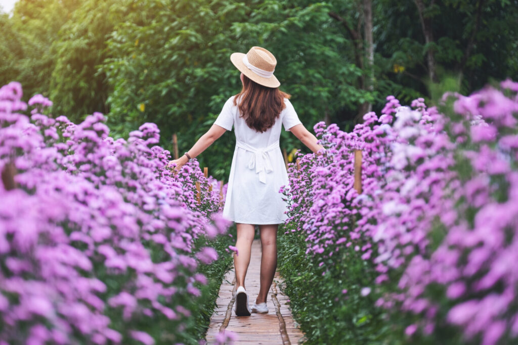 Rear view image of a beautiful young asian woman walking in Marg
