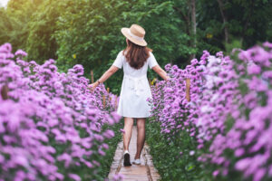 Rear view image of a beautiful young asian woman walking in Marg