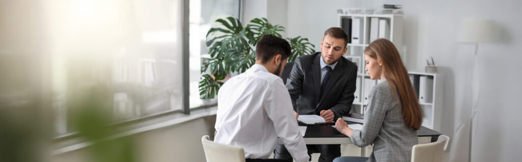 Young couple meeting with lawyer