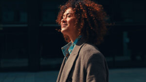 Young woman looking into the sun and smiling