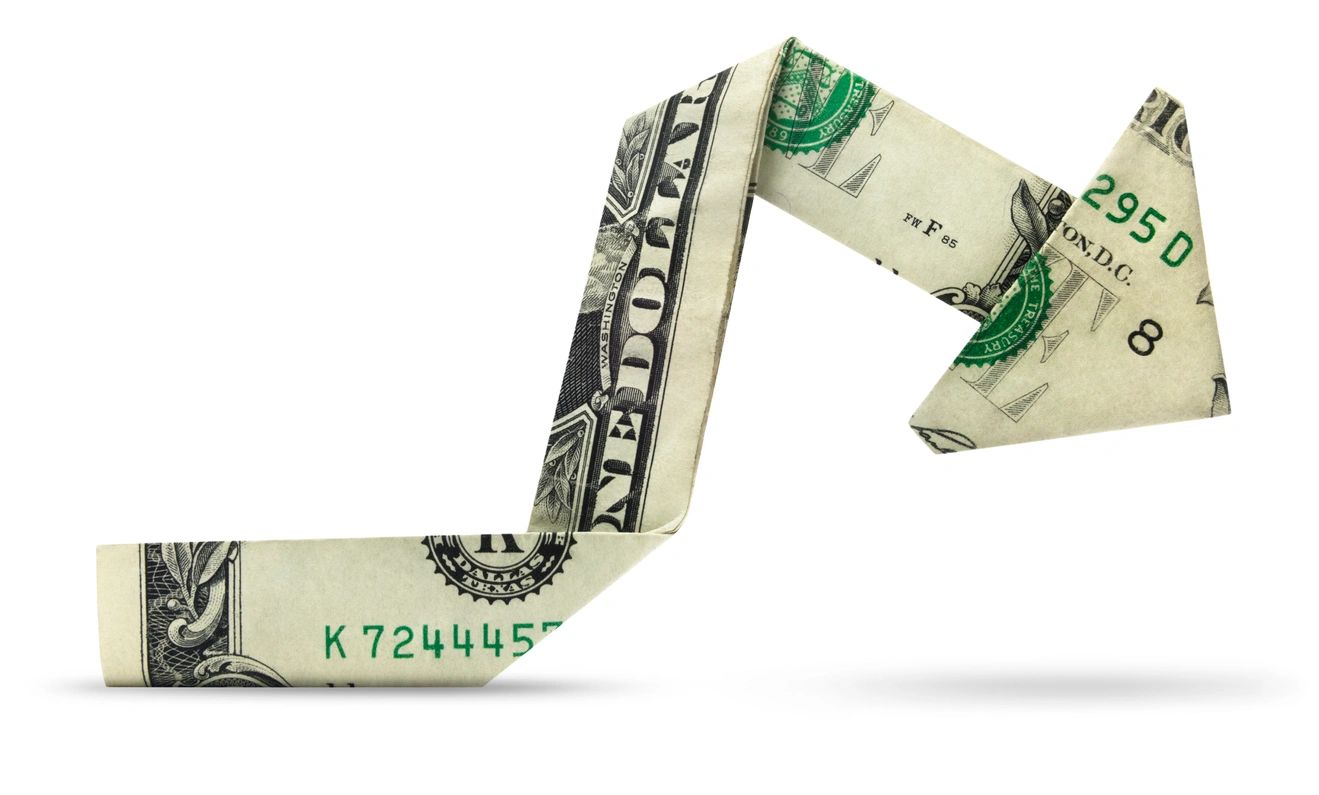 A dolloar bill folded into an arrow pointing to the right
