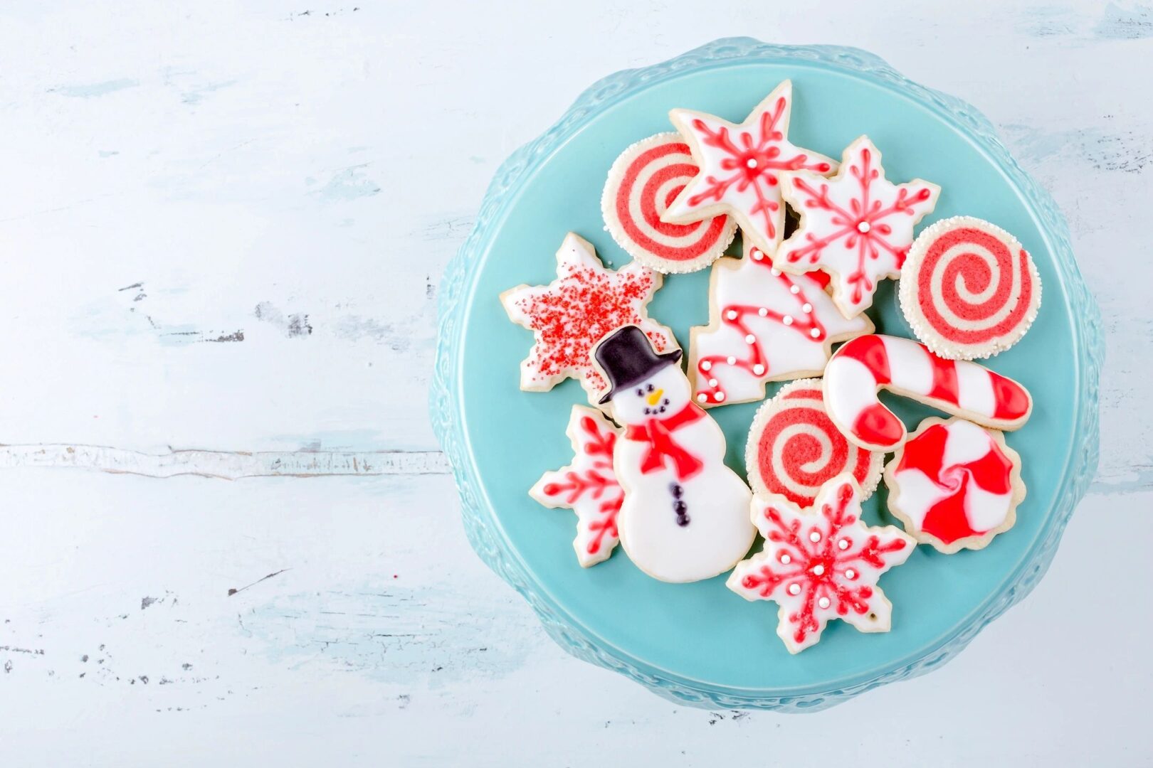 a blue plate with Christmas cookies