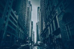 city image looking down center of a busy street flanked with tall buildings