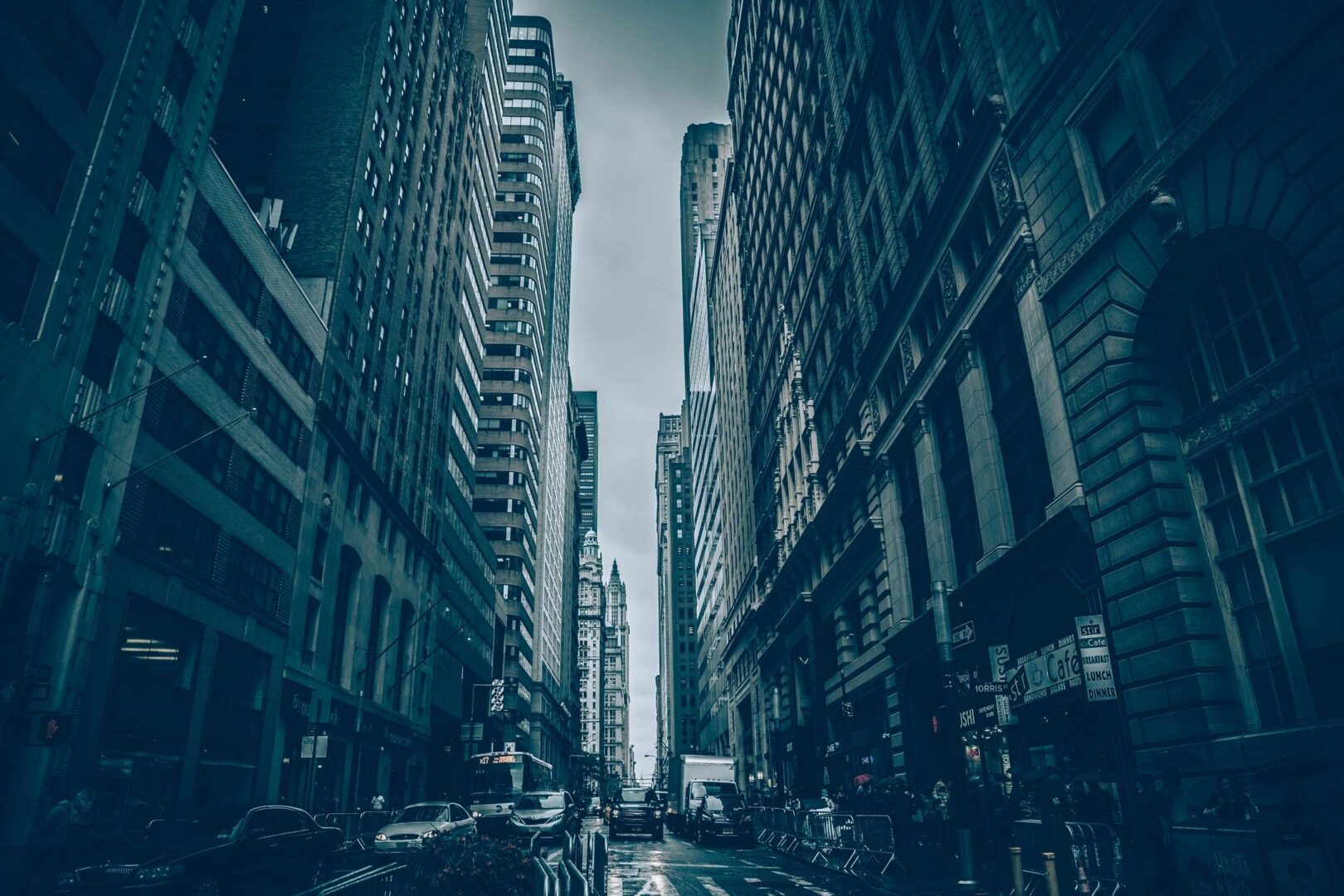 city image looking down center of a busy street flanked with tall buildings
