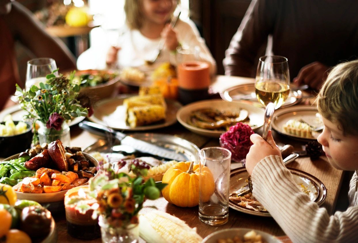 family gathered around a table for a thanksgiving meal
