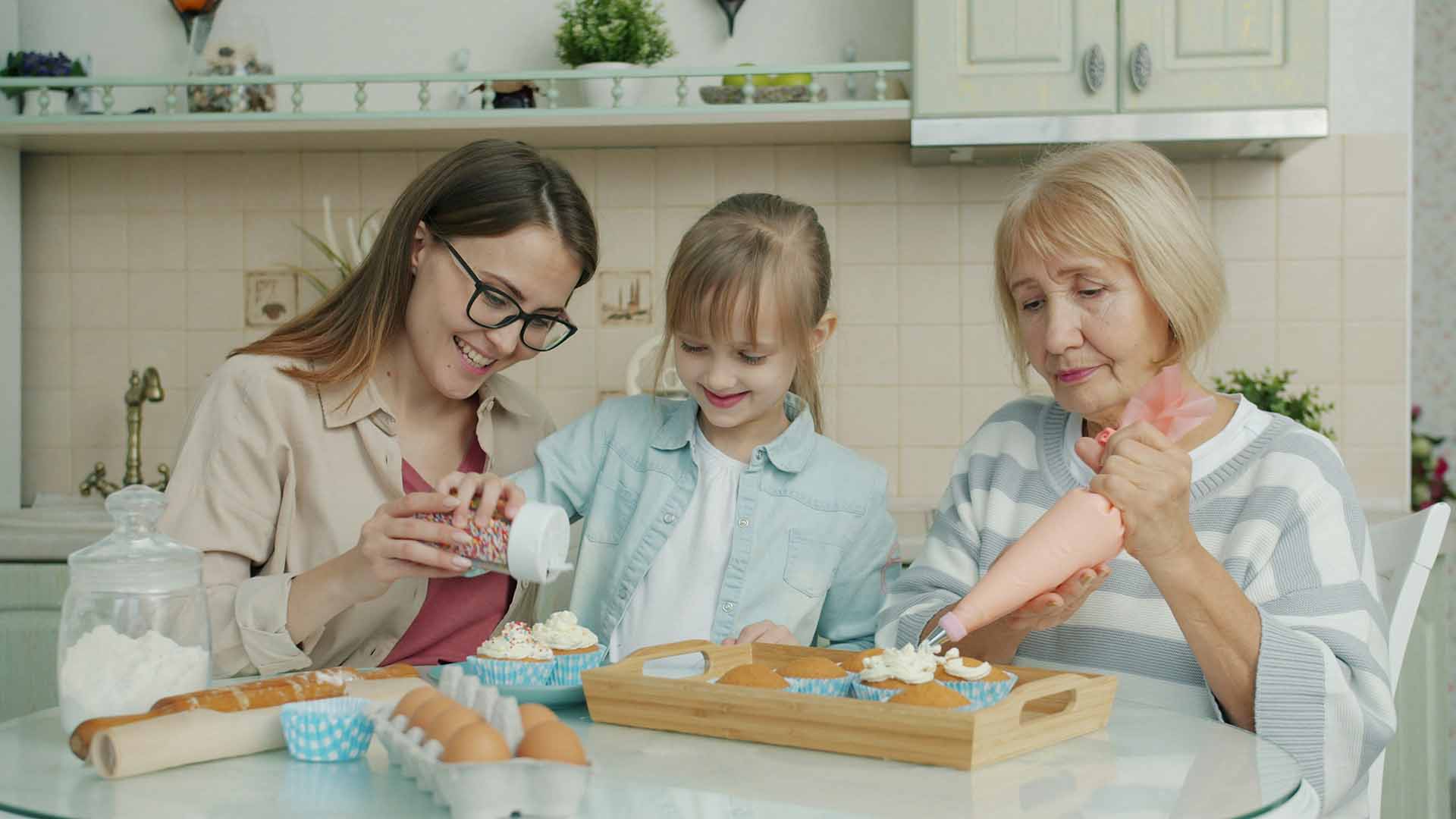 three generation of women baking cookies together talking about estate planning